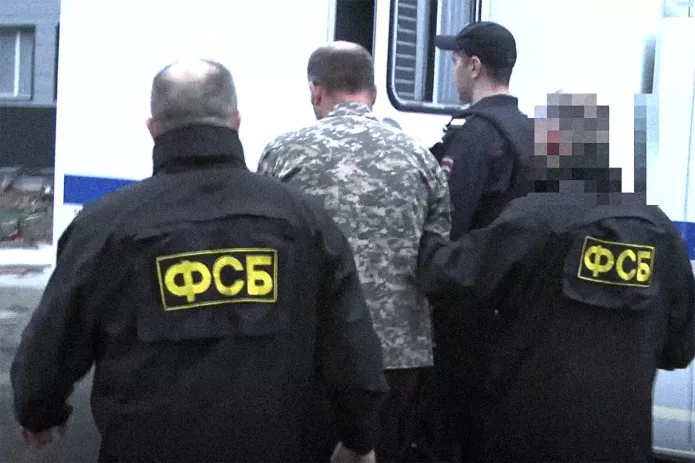 FSB officers are leading Vasily Votanovsky into a police van after a search / Screenshot from a video published by the FSB